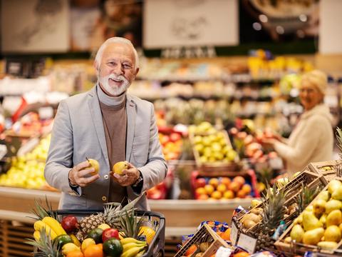 Mann kauft frisches Obst und Gemüse im Einkaufsladen